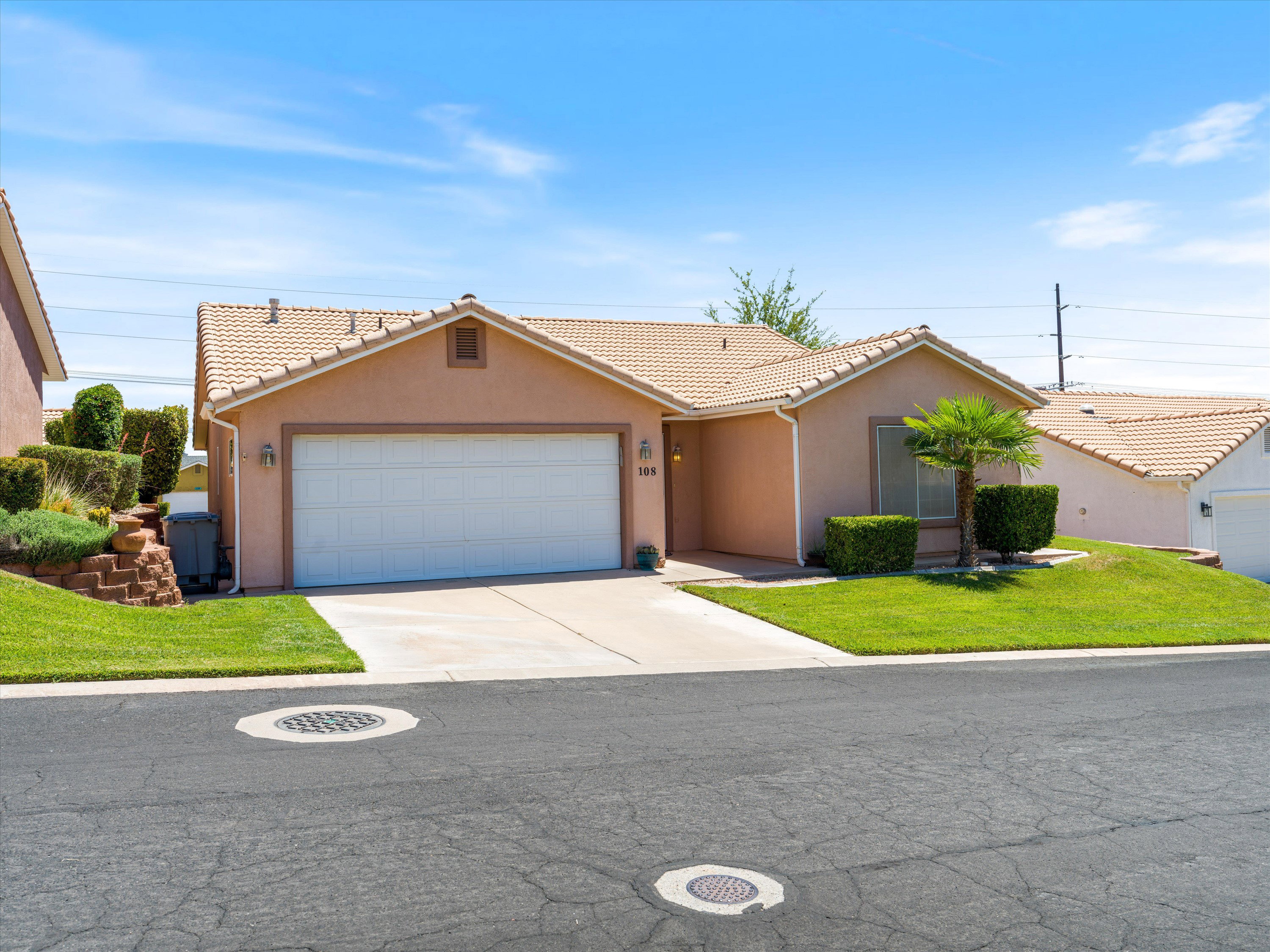 Single-story residence featuring a stucco exterior, concrete tile roof, and an attached two-car garage