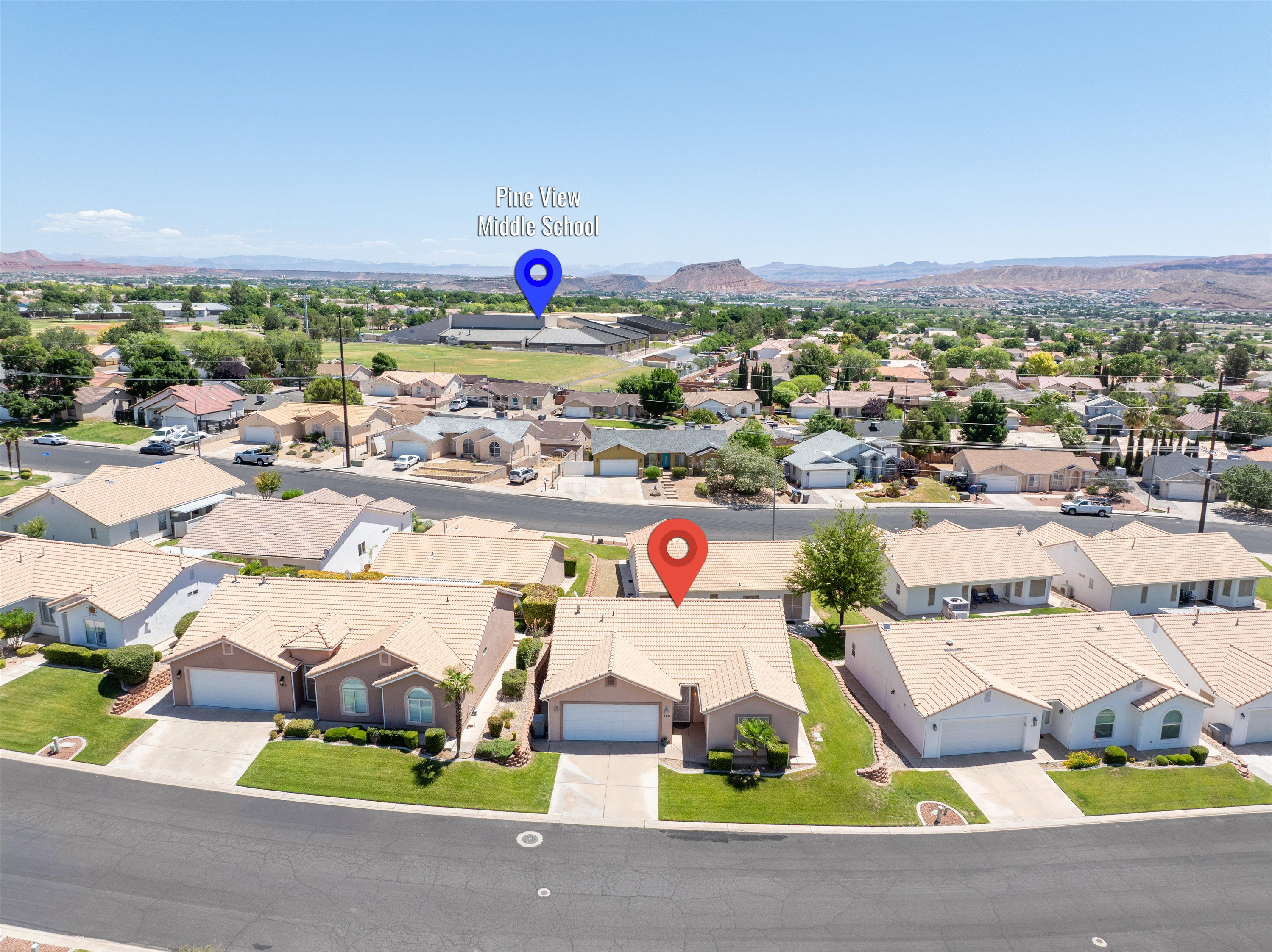 Aerial perspective showcasing a residential neighborhood with surrounding desert mountains