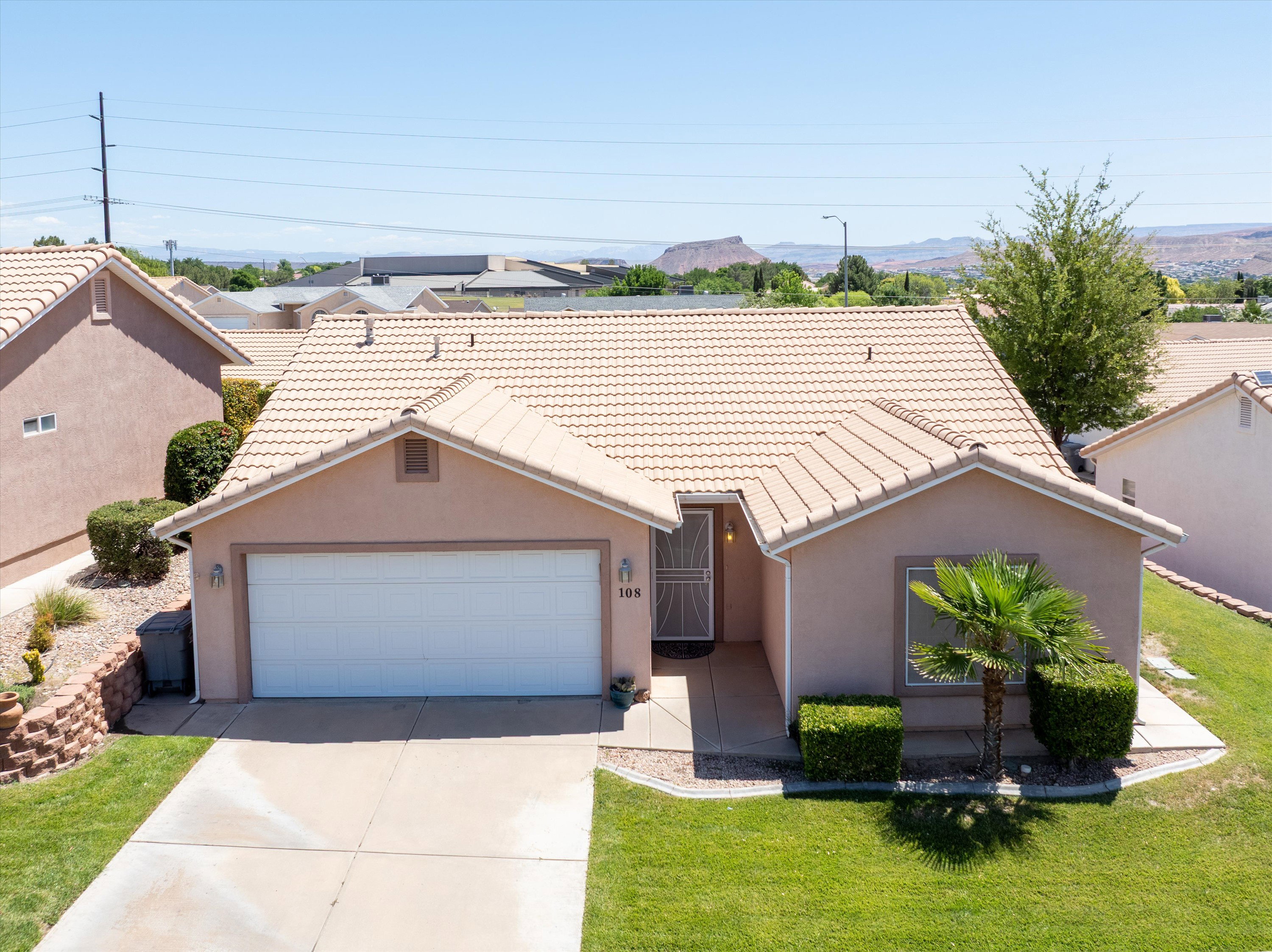 Single-story residence featuring a stucco exterior, tiled roof, and an integrated two-car garage
