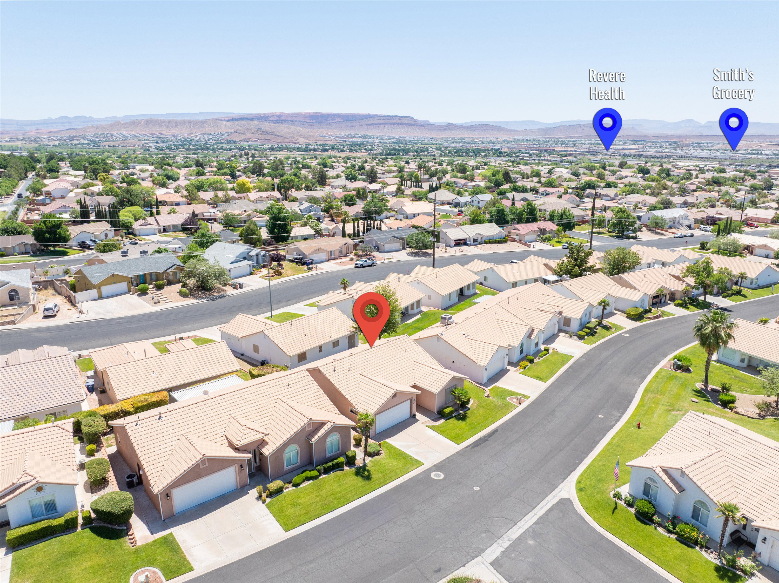 Residential neighborhood featuring single-story homes with light-colored roofs and landscaped front yards