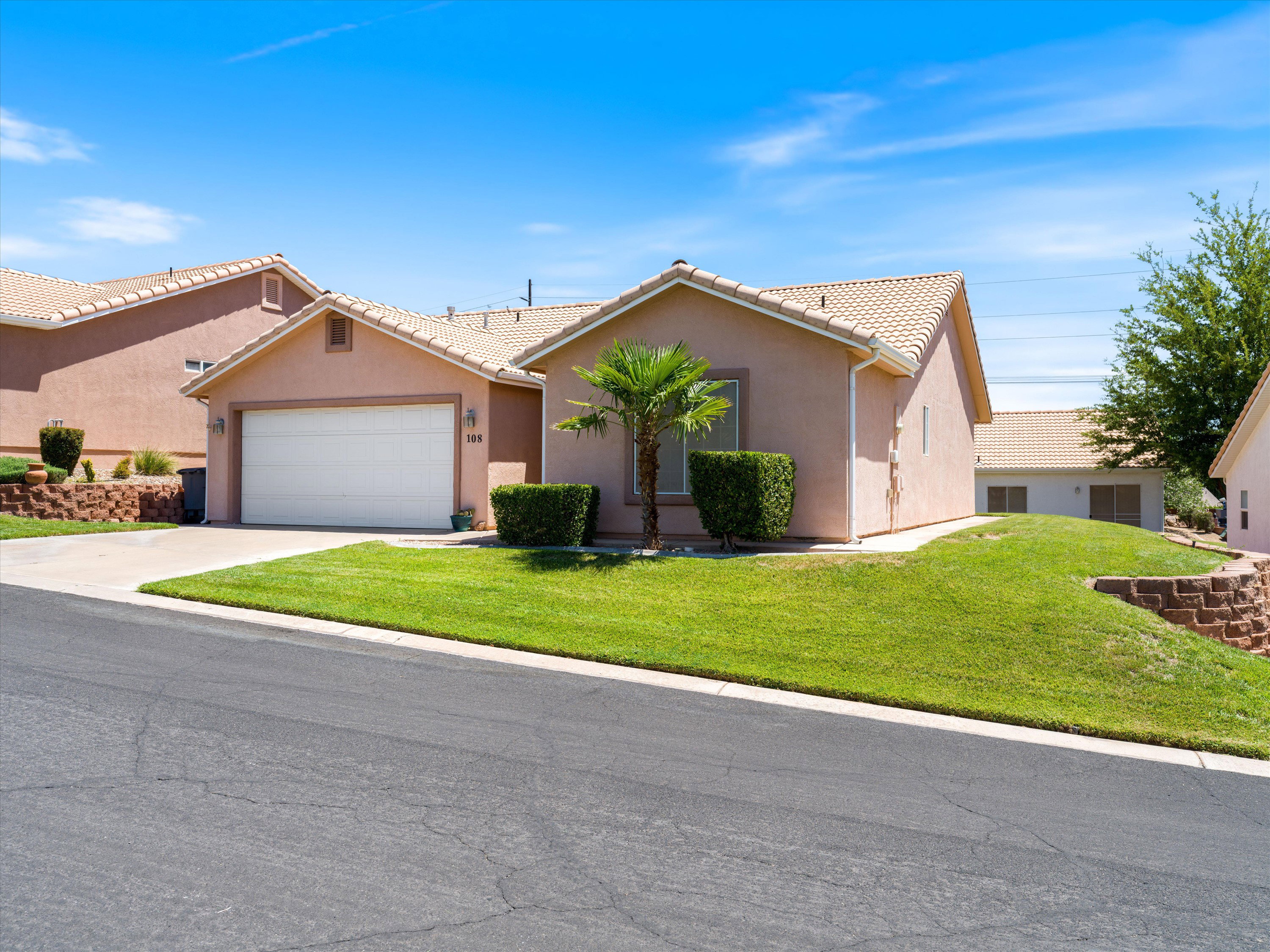 Desert contemporary stucco exterior with a single-car garage and concrete driveway