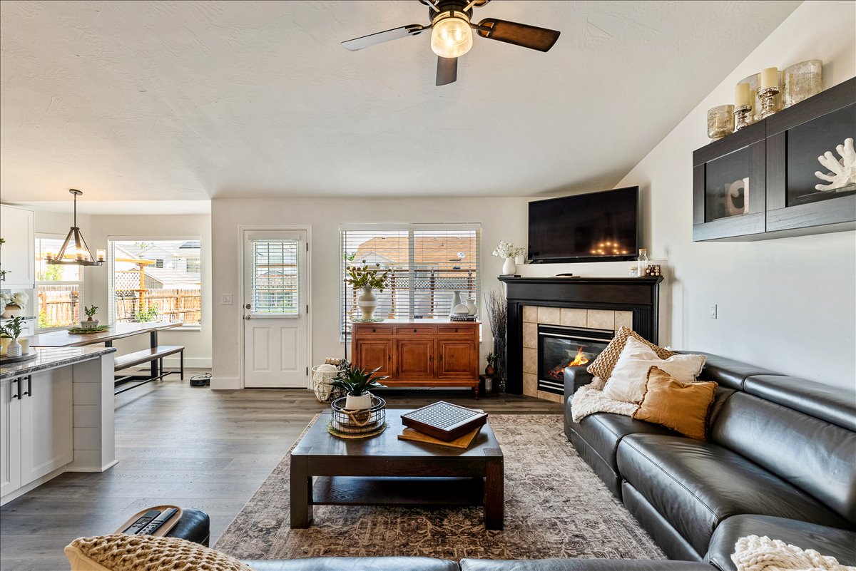 Spacious living area featuring high ceilings, wood-finish flooring, and ample natural light