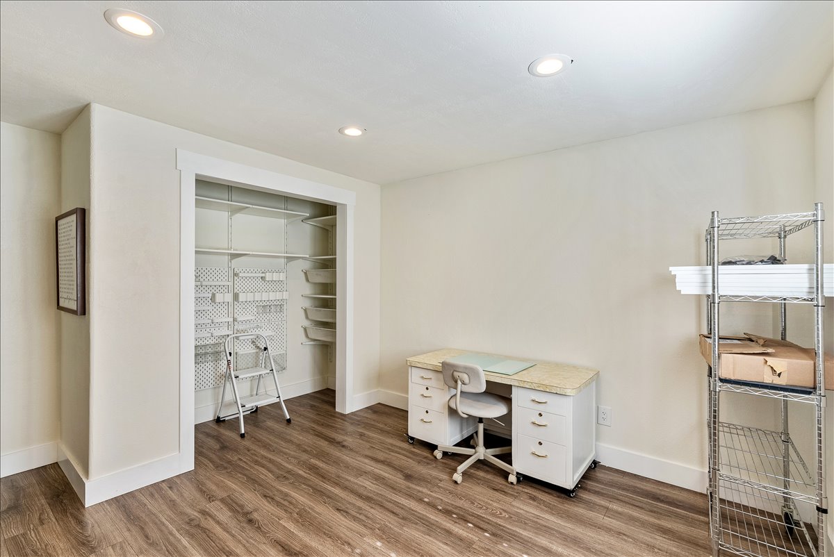 Recessed lighting illuminates wood-finish flooring