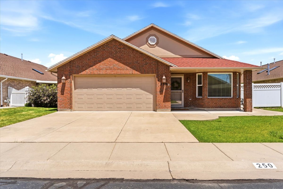 Brick exterior with a prominent attached garage and a red shingle roof