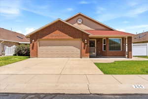 Brick exterior with a prominent attached garage and a red shingle roof