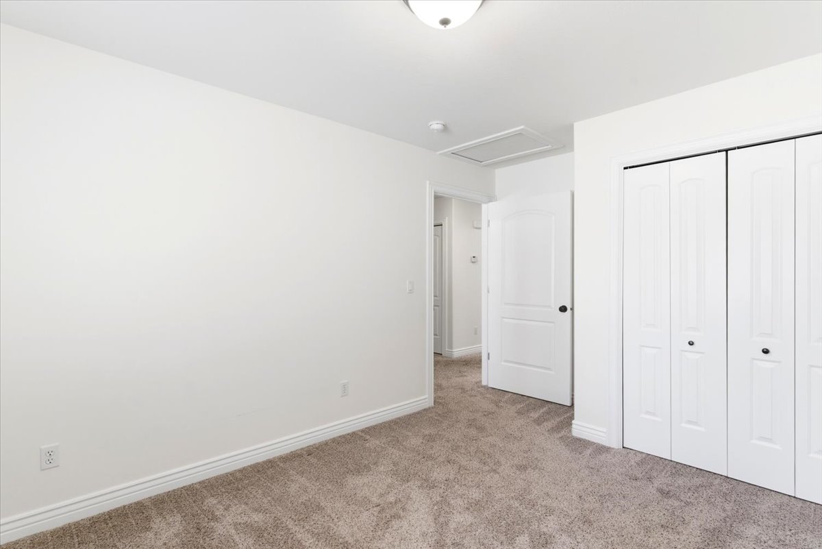Neutral color palette featuring wall-to-wall carpeting, white baseboards, and white walls