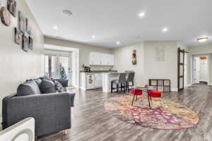 Built-in wet bar with white cabinetry and a breakfast bar