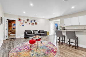 Recreation room featuring wood-finish flooring and recessed lighting