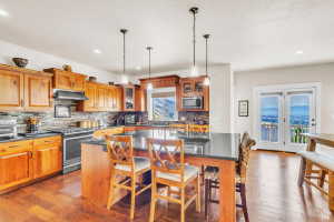 Kitchen featuring wood cabinetry, stainless steel appliances, and dark countertops
