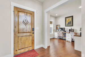 Arched wood-panel entry door with decorative ironwork