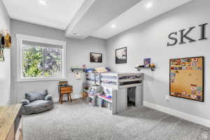 Carpeted room with a large window