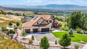 Contemporary home with a multi-car garage, solar panels, and a prominent pitched roofline