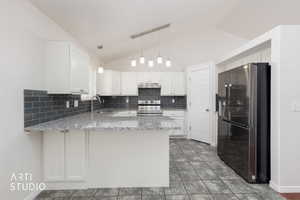 Kitchen featuring vaulted ceilings, white cabinetry, dark subway tile backsplash, light granite countertops, and tiled flooring