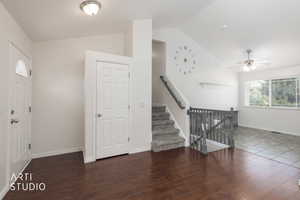 Entryway featuring wood-finish flooring, a white paneled door with an arched glass insert, and a flush-mount ceiling light