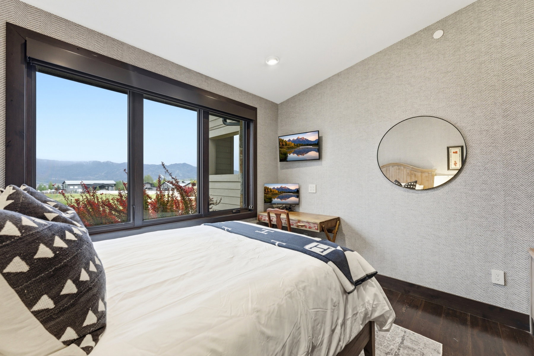 Dark-framed windows offering a mountainous landscape