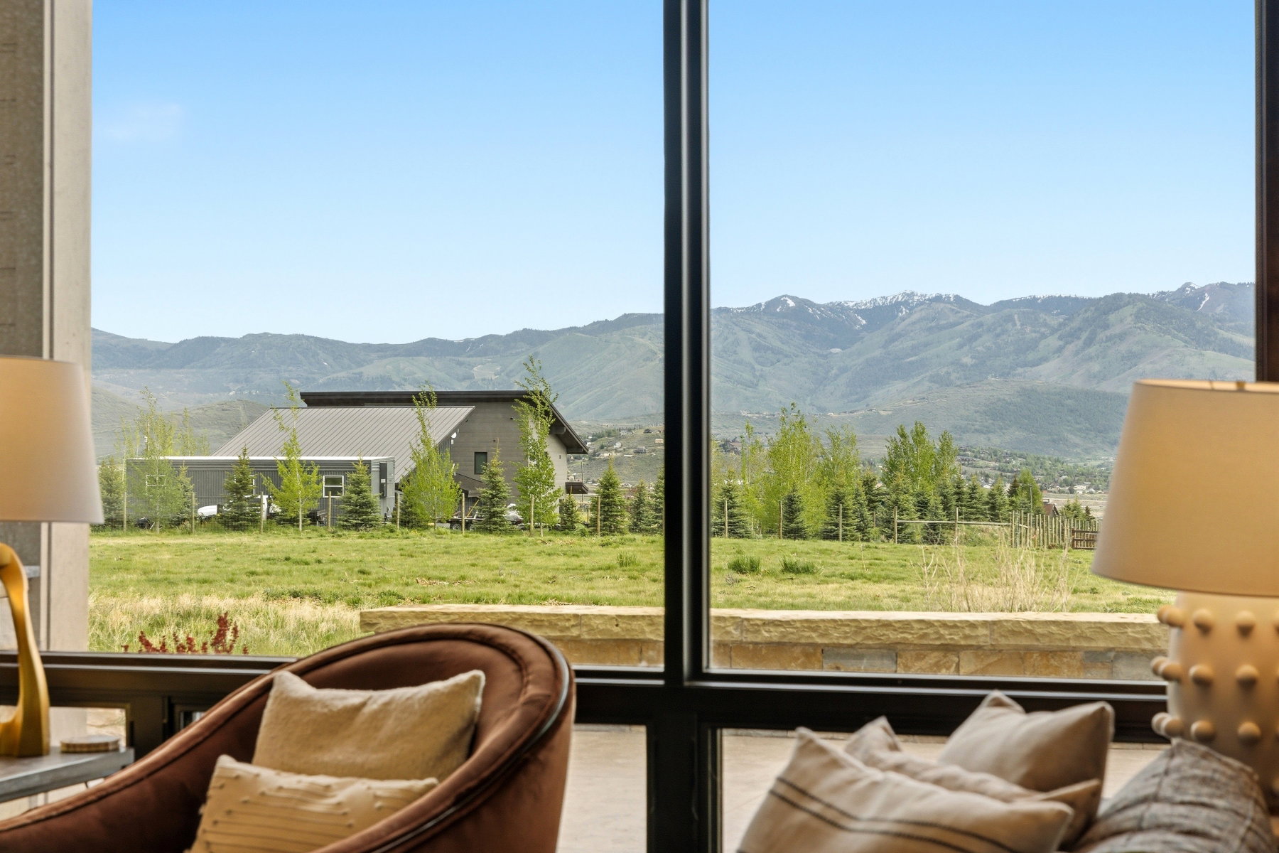 Expansive window framing distant mountains with snow-capped peaks