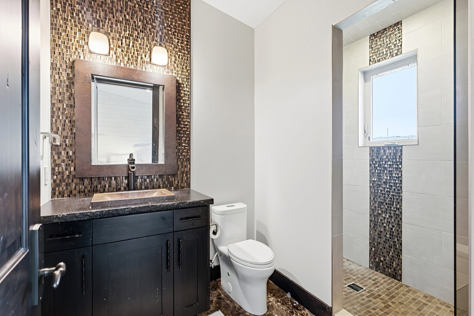 Bathroom featuring a dark wood-finish vanity with a dark countertop and a rectangular vessel sink