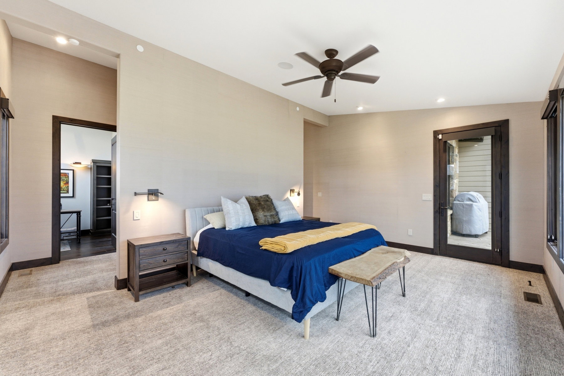 Spacious room featuring neutral carpeting, a ceiling fan, recessed lighting, and a glass-paneled door