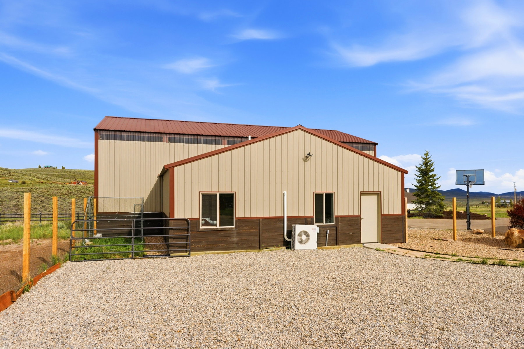 Metal structure featuring a tan upper facade, brown lower facade, and a complementary brown roof