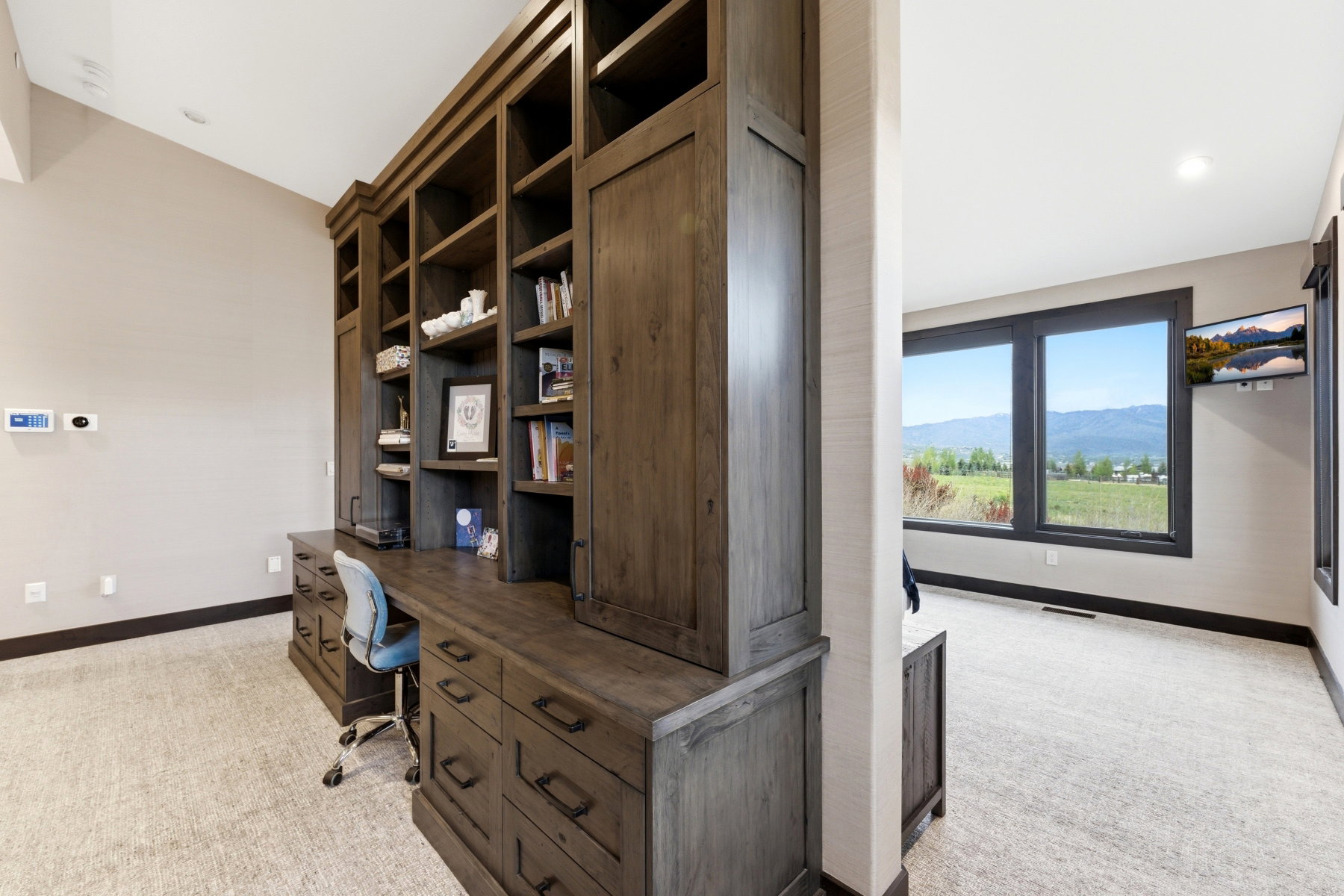 Built-in wood-finish cabinetry featuring open shelving and integrated desk space