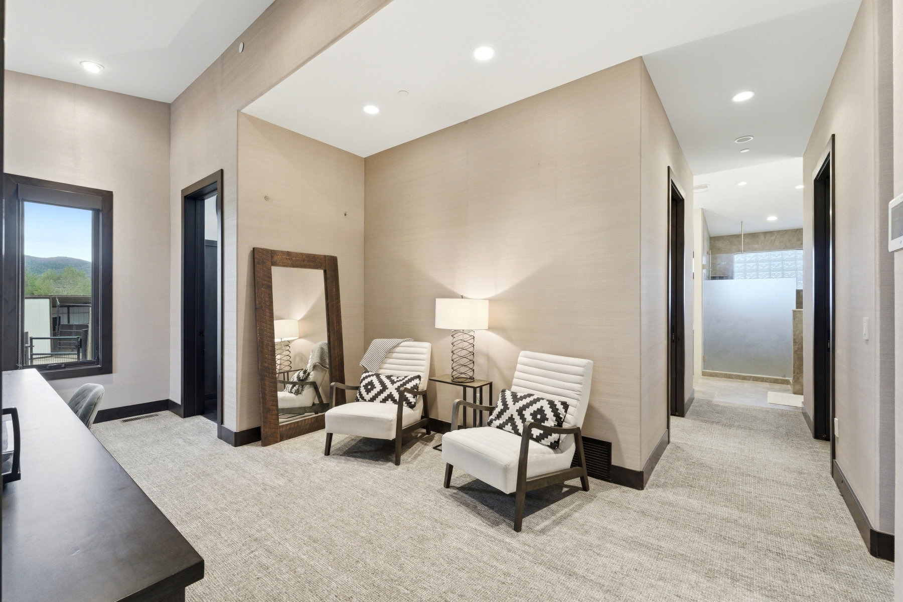 Carpeted hallway featuring recessed lighting and dark wood trim