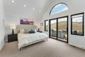 Vaulted ceiling with white shiplap, recessed lighting, and a large arched window