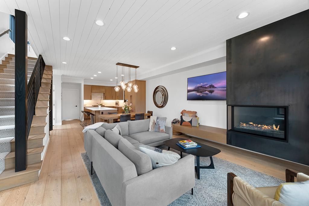 Open concept living area featuring wood-finish flooring and a shiplap ceiling