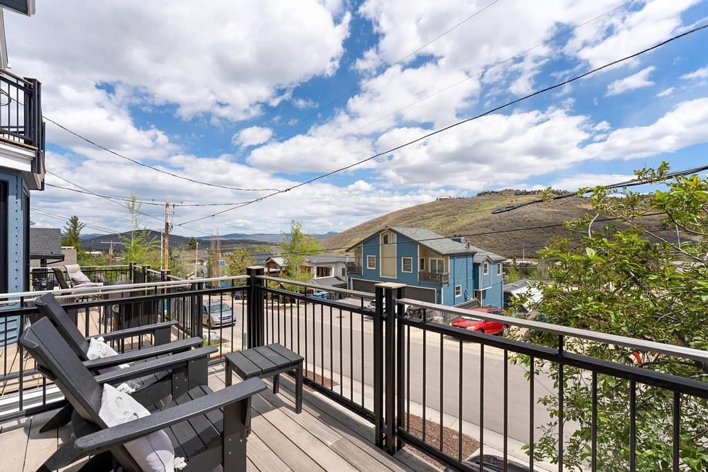 Exterior balcony with composite decking and black metal railings