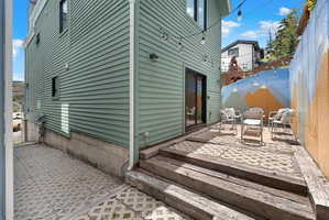 Private outdoor patio area featuring a sliding glass door entry