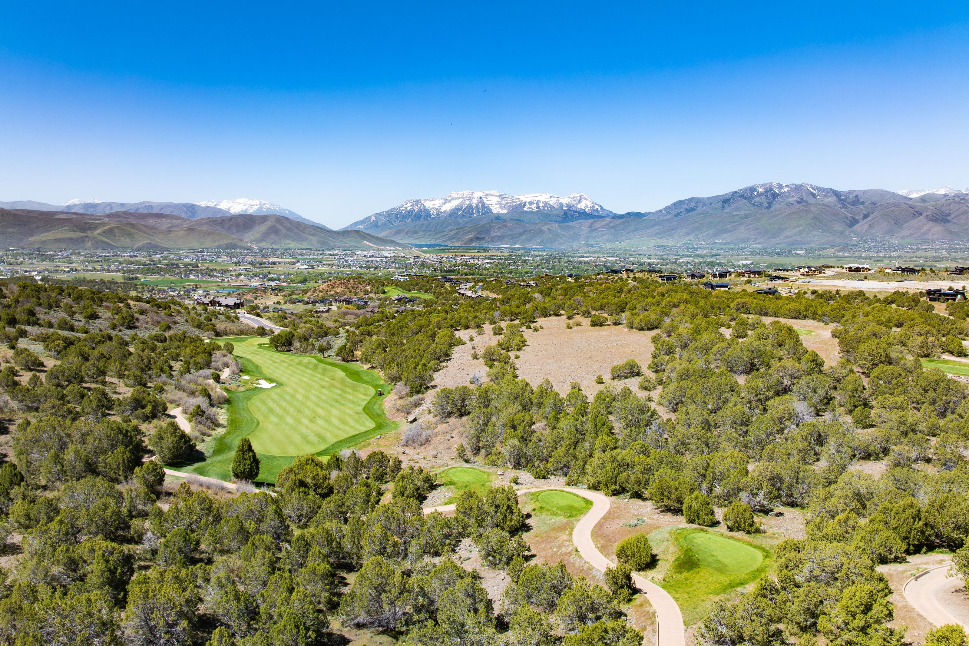 Expansive golf course terrain surrounded by natural foliage