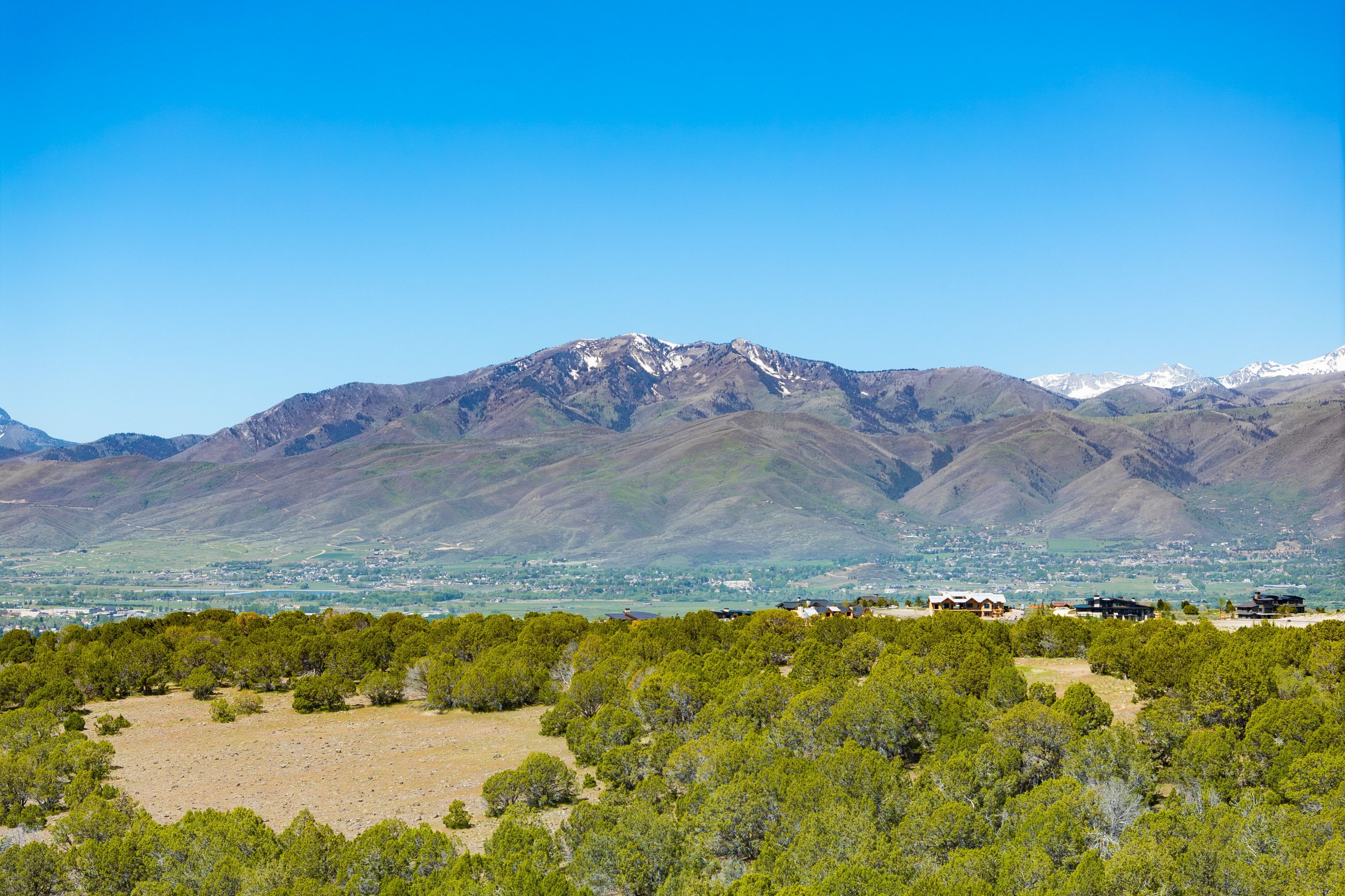Mountain range backdrop featuring snow-capped peaks and expansive natural landscaping
