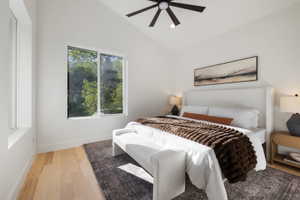 Vaulted white ceilings featuring a contemporary ceiling fan