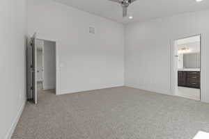 Spacious room featuring vaulted ceilings, light-toned carpeting, and recessed lighting