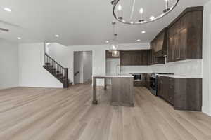 Expansive open-concept living area featuring light wood-finish flooring