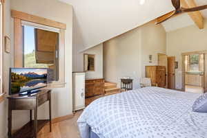 Vaulted ceiling with exposed wood beam and ceiling fan