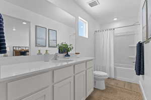 Bathroom featuring a single vanity with a white countertop, white cabinetry, and a chrome faucet