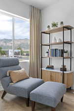 Expansive window with mountain scenery and a built-in shelving unit featuring a wood-finish base with reeded detailing and a white stone top