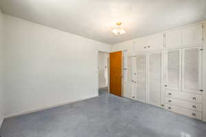 Built-in white cabinetry with louvered doors and drawer storage