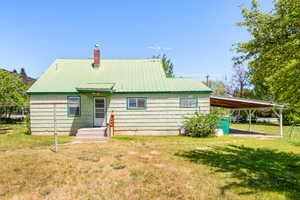 Light green siding exterior with a bright green metal roof