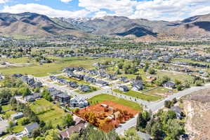 Aerial perspective showcasing a residential area set against a mountainous backdrop