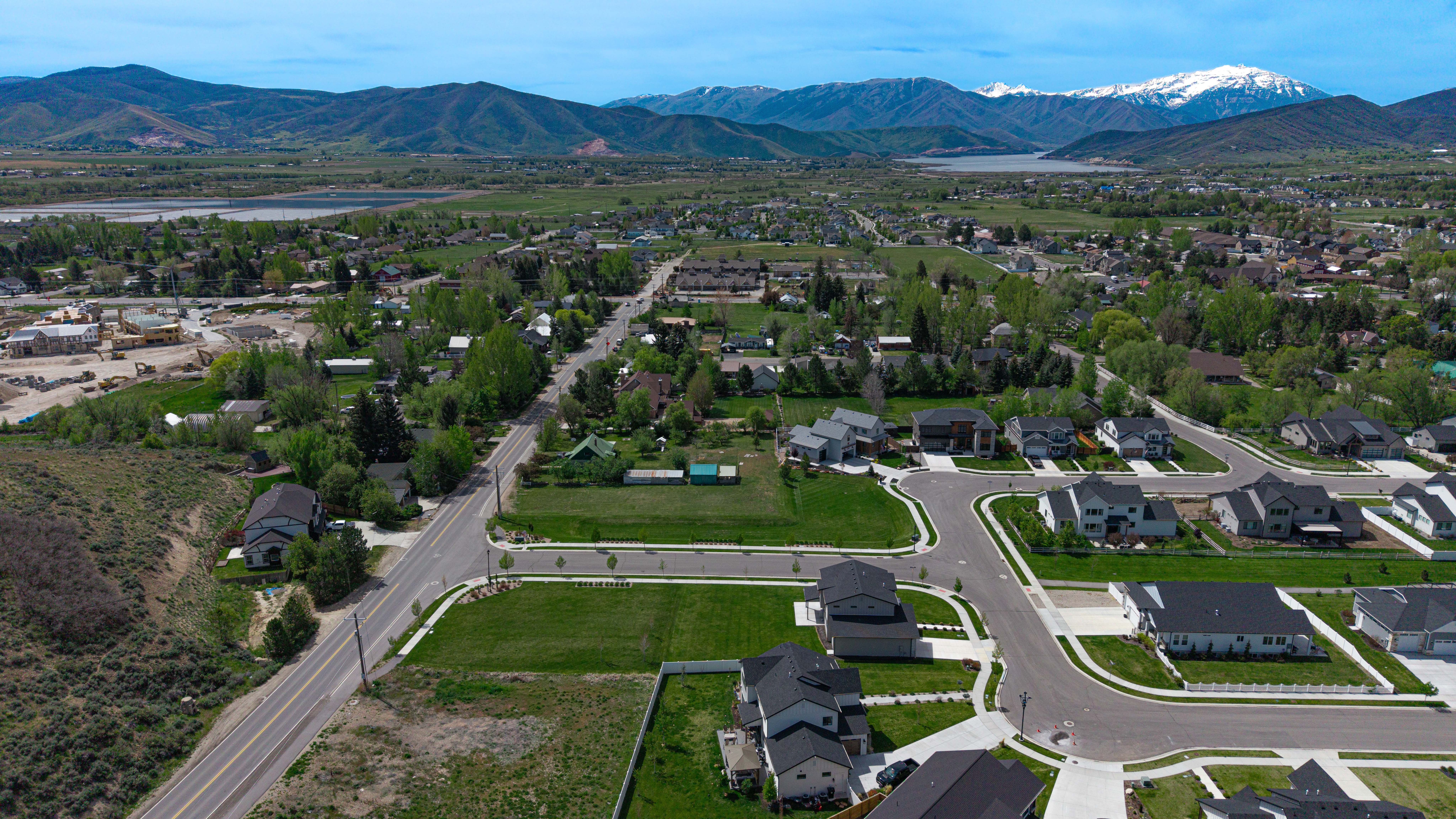 Expansive residential development featuring newly constructed homes with dark roofs and light-colored siding