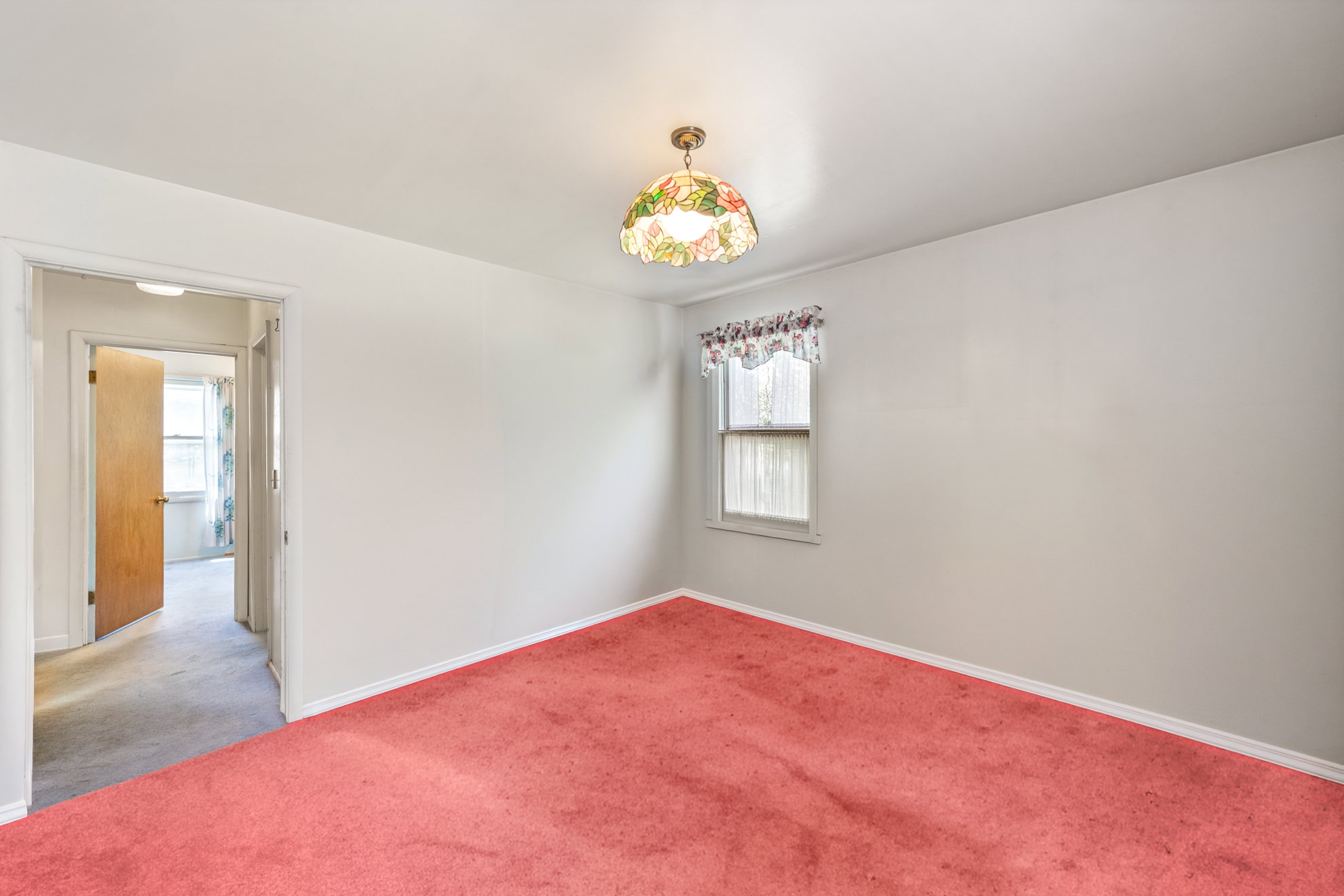 Room featuring red wall-to-wall carpeting and white painted walls