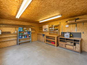 Garage workshop featuring oriented strand board walls and ceiling