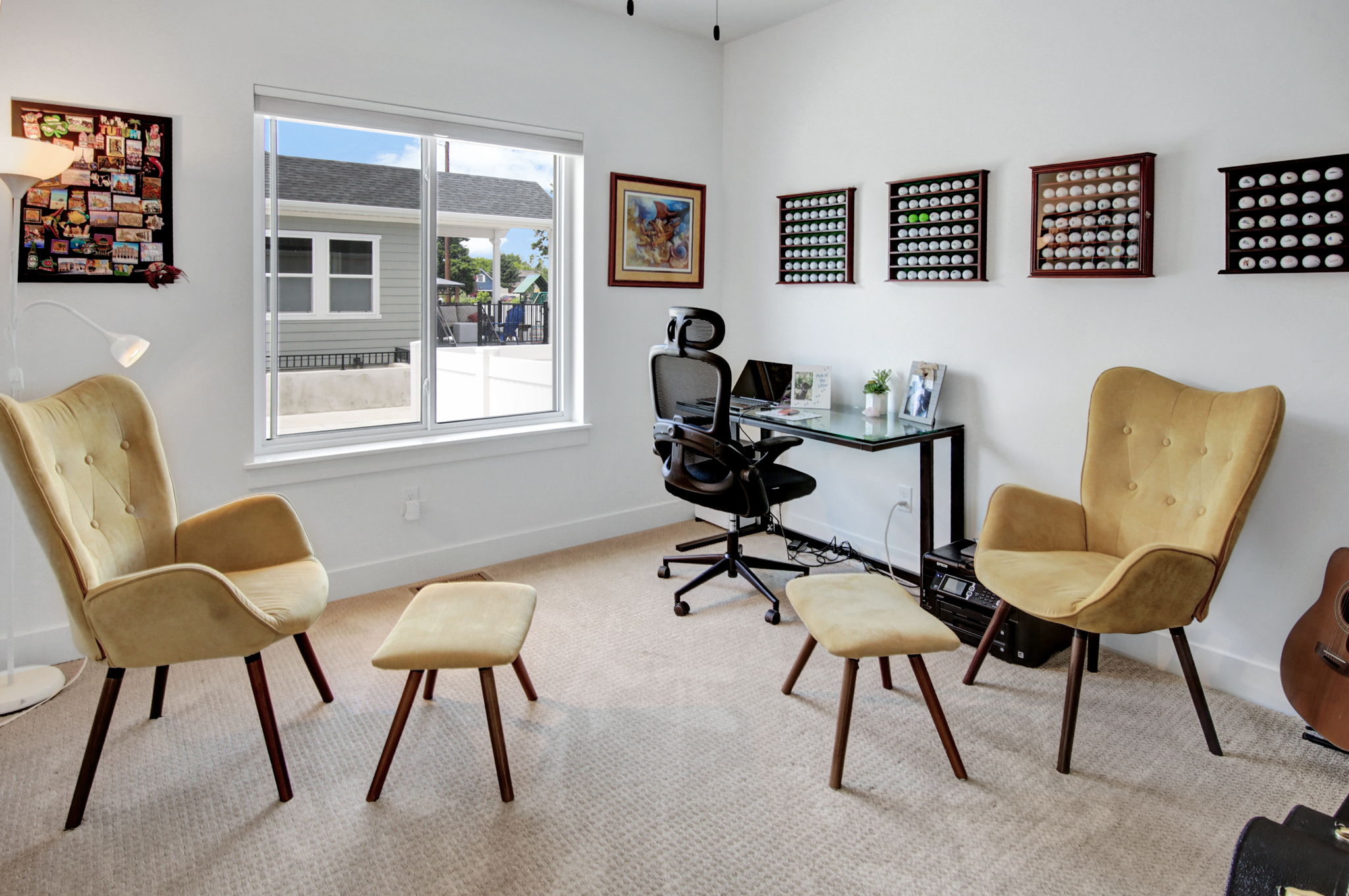Bright room featuring white walls, a large window, and light-colored carpeting
