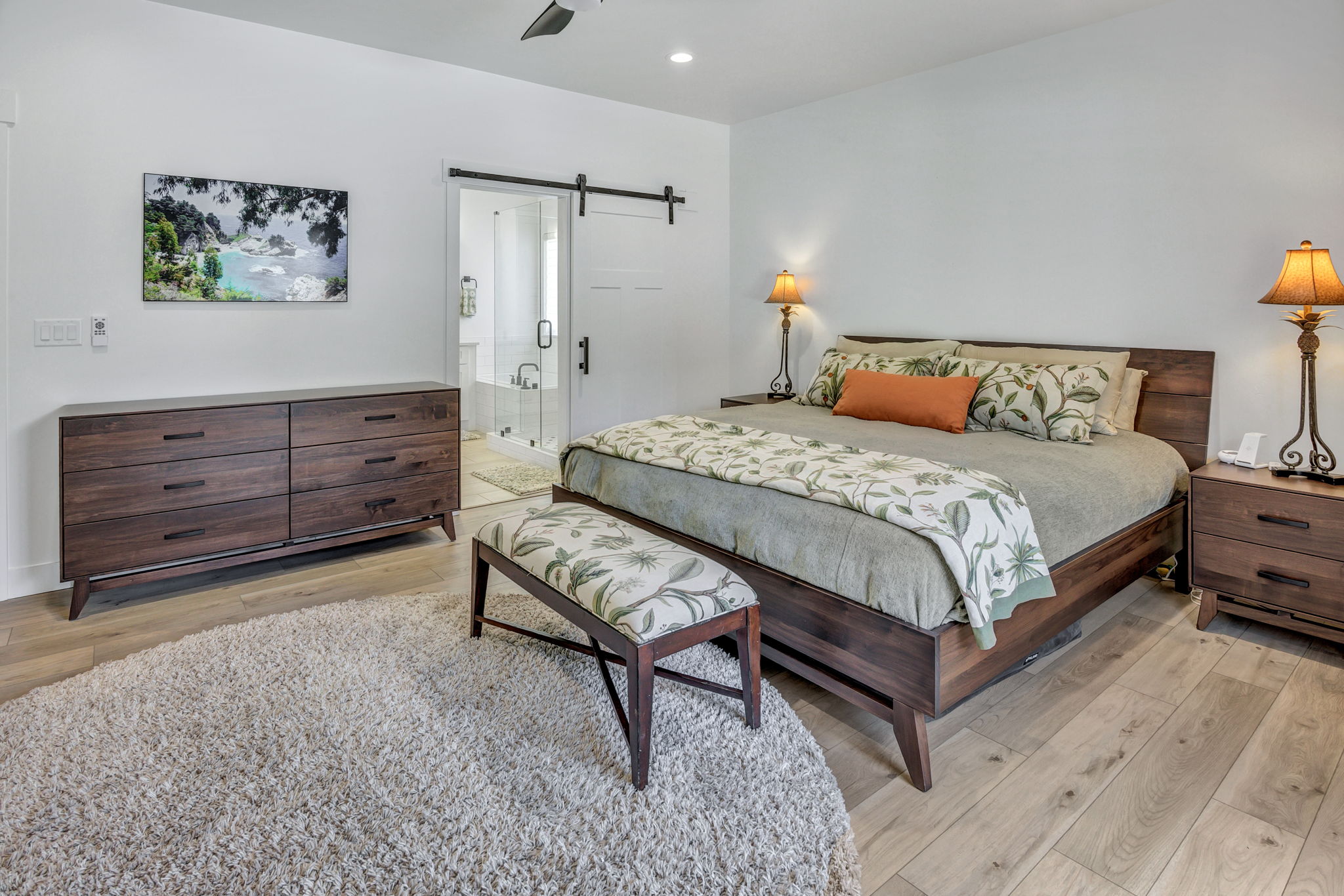 Light LVP flooring complements a dark wood-finish bed frame and dresser