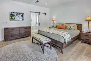 Light LVP flooring complements a dark wood-finish bed frame and dresser