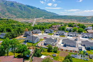 Residential development featuring contemporary homes with dark shingle roofs and light-colored siding