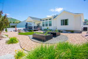Contemporary backyard featuring drought-tolerant landscaping with gravel paths and decorative rocks