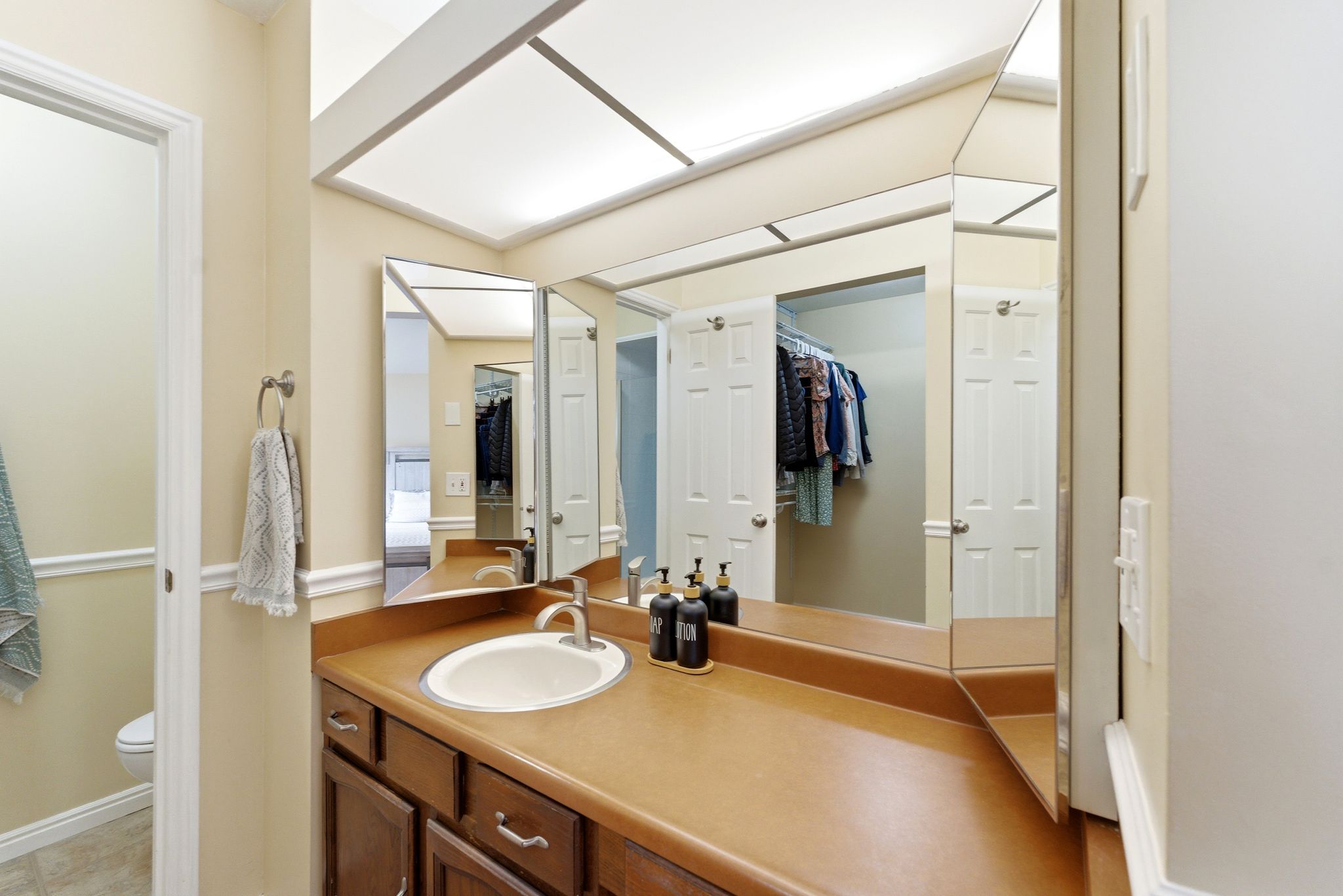 Bathroom vanity featuring a single basin, brushed nickel faucet, and a spacious countertop