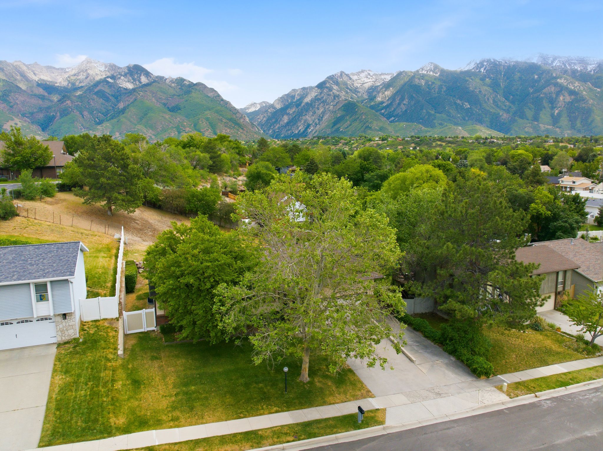 Expansive mountain backdrop with scattered snowcaps provides a dramatic setting